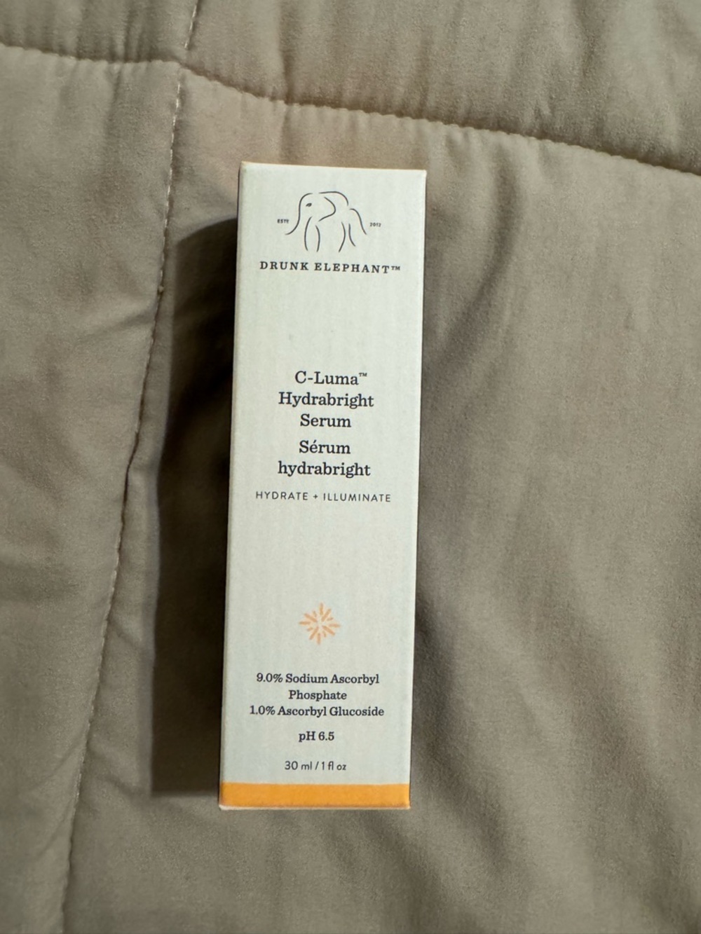 Drunk Elephant C-Luma Hydrabright Serum – Cream and Orange Accents